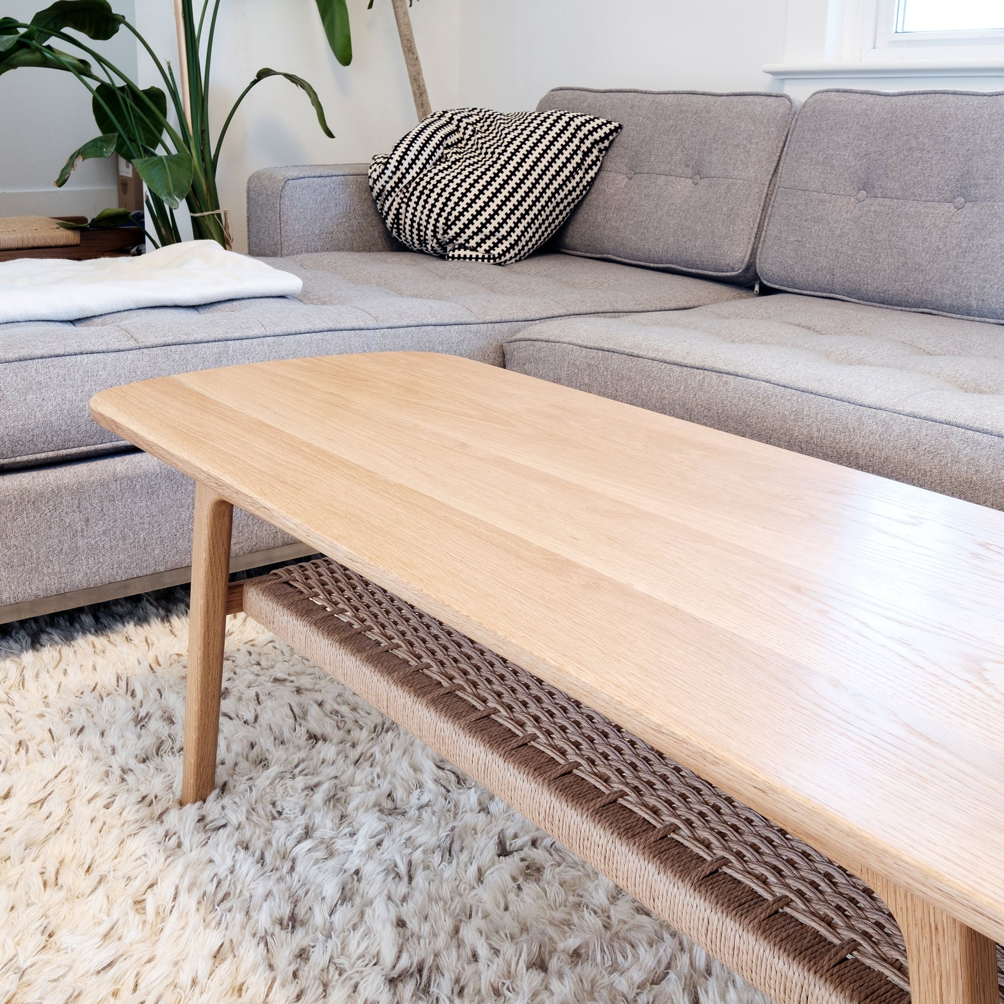 Mid century white oak coffee table, danish cord lower shelf, splayed legs, living room couch, rift sawn