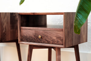 Mid mentury walnut nightstand with one drawer, one open shelf, bevelled front edge, close up, side view, burl grain